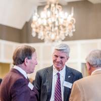 Dan DeVos talking with Mike Jandernoa and another guest.